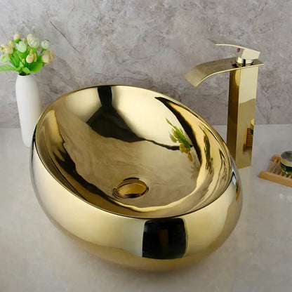 Golden plated ceramic basin sink with oval shape and sleek reflective metallic finish for bathroom decorbites golden plated