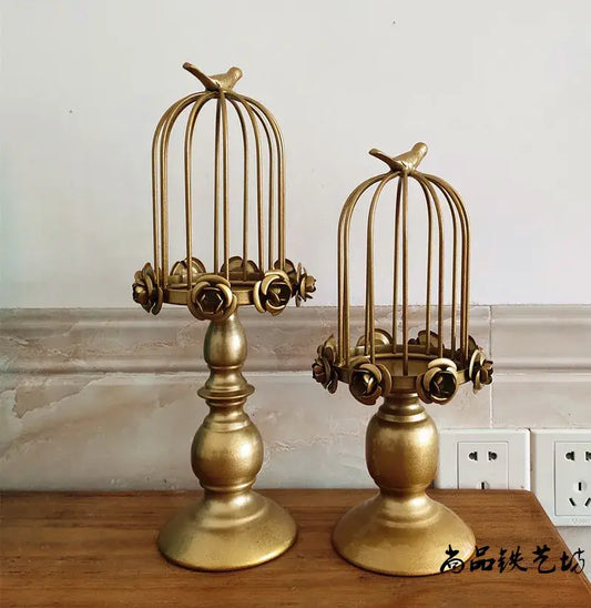 Golden metal birdcage style ornament candle holder with rose embellishments and perched birds for dining room decor