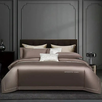 The golden satin egyptian cotton bedding set features a taupe satin duvet cover with white embroidery and gold logo