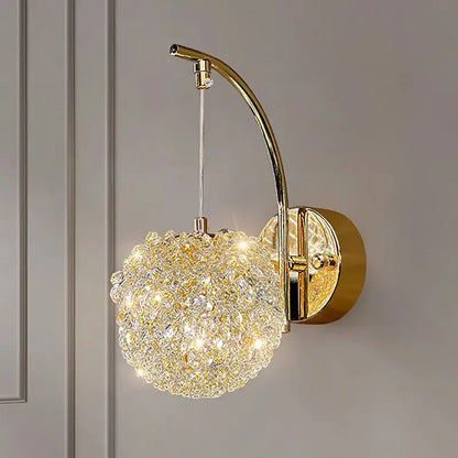 Gold-toned wall lamp with crystal beads featuring a textured glass globe hanging from an arched metal arm for living room decorbites crystal beads