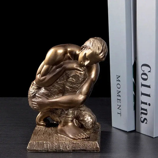 Bronze-colored resin sculpture of a crouching muscular golden thinker bodybuilder ideal for office desk decor