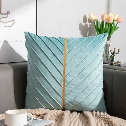 A soft teal velvet cushion cover with chevron pattern and gold trim from decorbites golden velvet patchwork set