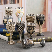 A collection of gothic skull goblets with metallic rims featuring decorbites dragon skull and skeletal hand designs