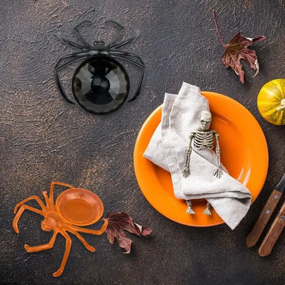 Black plastic skull spider tray with faceted glossy center serving as gothic gemstone storage plate