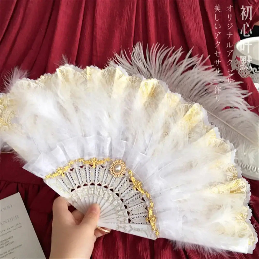 Elegant white lace fan with gold filigree trim and pearl clasp featuring decorbites elegant gemstone handle