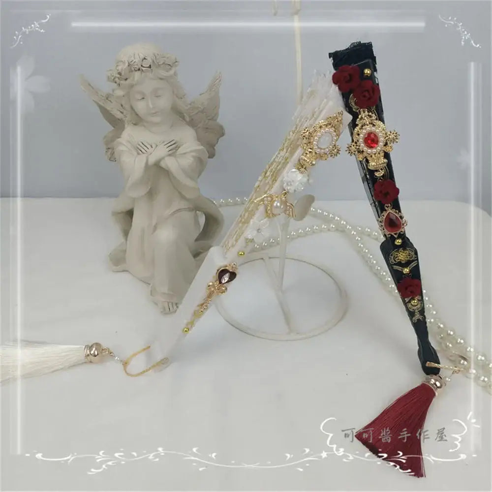 Elegant black and gold lace fan with red floral embellishments and decorbites elegant gemstone handle for party decor