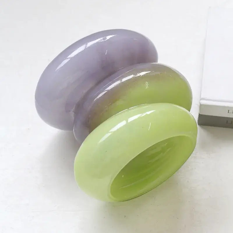 Three stacked glossy bangles in gradient color lavender and lime green complement decorbites geometric glass vase design