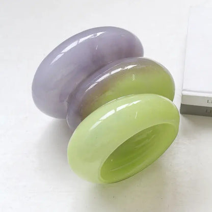 Three stacked glossy bangles in gradient color lavender and lime green complement decorbites geometric glass vase design