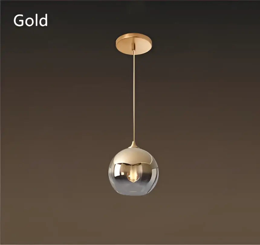 Gold-finished spherical pendant light with reflective gradient glass ball for elegant dining room chandelier set