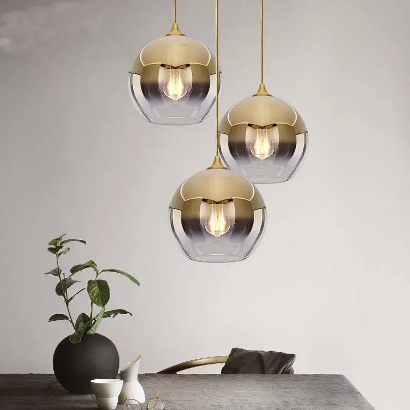 Three modern pendant lights with gold-toned metal frames and gradient glass ball shades for dining room chandelier set