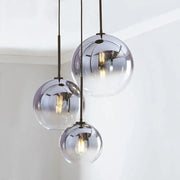 Set of three spherical gradient glass ball pendant lights with frosted and mirrored finish for dining room chandelier