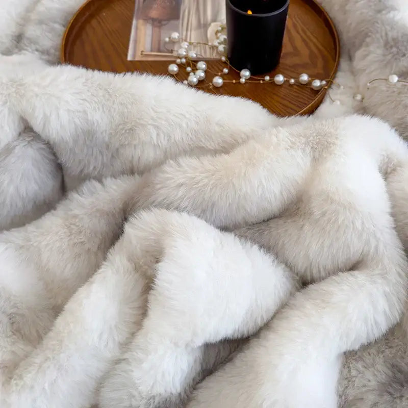 A plush off-white faux fur throw blanket with soft fluffy texture complementing decorbites gradient grey fleece decor