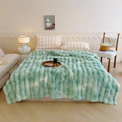 A plush mint-green and white tie-dye faux fur throw blanket contrasting decorbites gradient grey cashmere fleece chunky knit throw