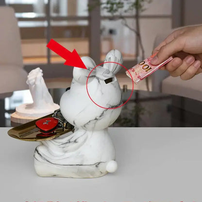 White marble-patterned rabbit-shaped money box with black slot and gold tray holding keys for decorbites graffiti bear figurine storage