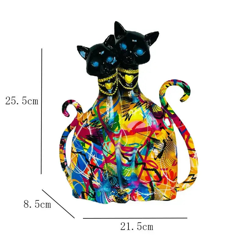 Vibrant abstractly painted resin decorbites cat couple sculpture featuring two black cats with glowing blue eyes and gold necklaces