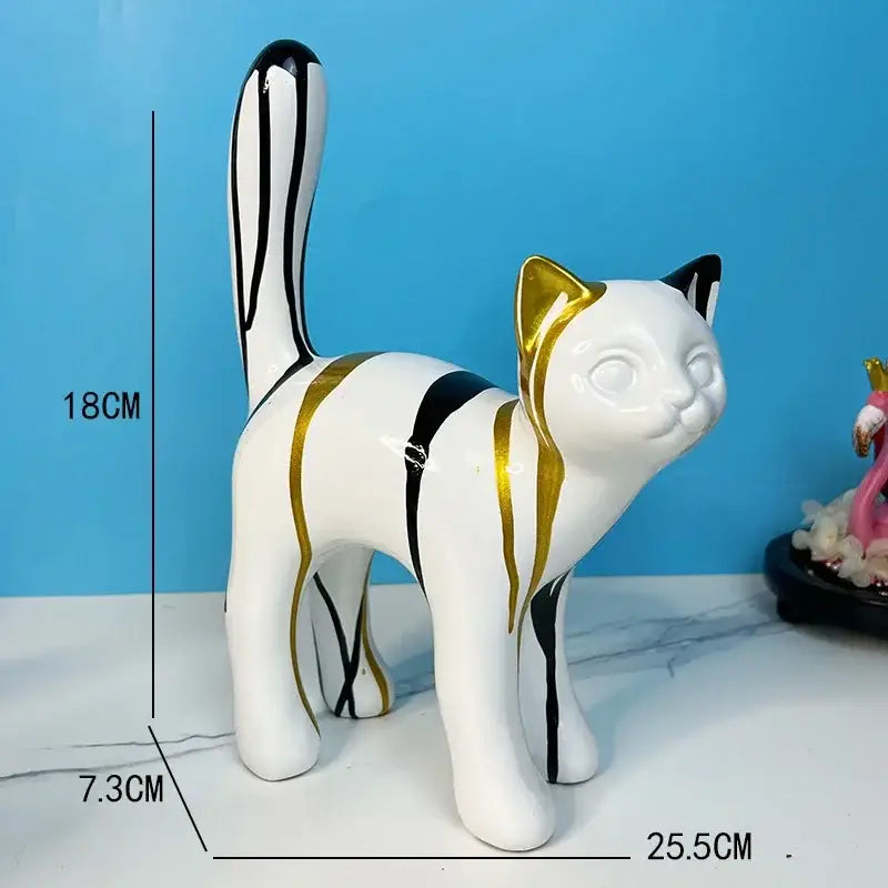 A sleek white ceramic graffiti cat desk storage statue with bold black and gold stripes for living room decor