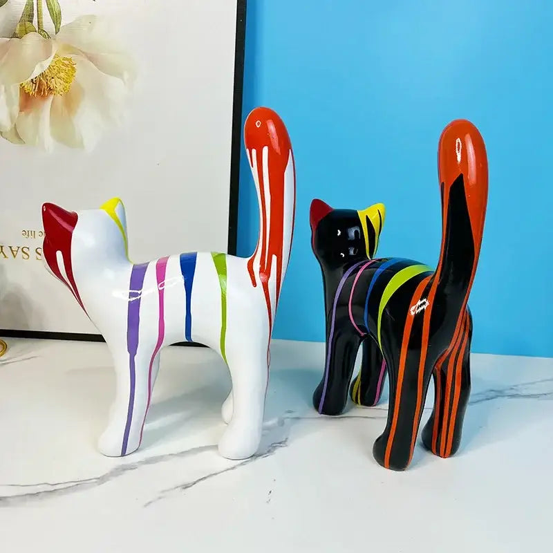 Two glossy ceramic graffiti cat desk storage statues in black and white with vibrant stripes for living room decor