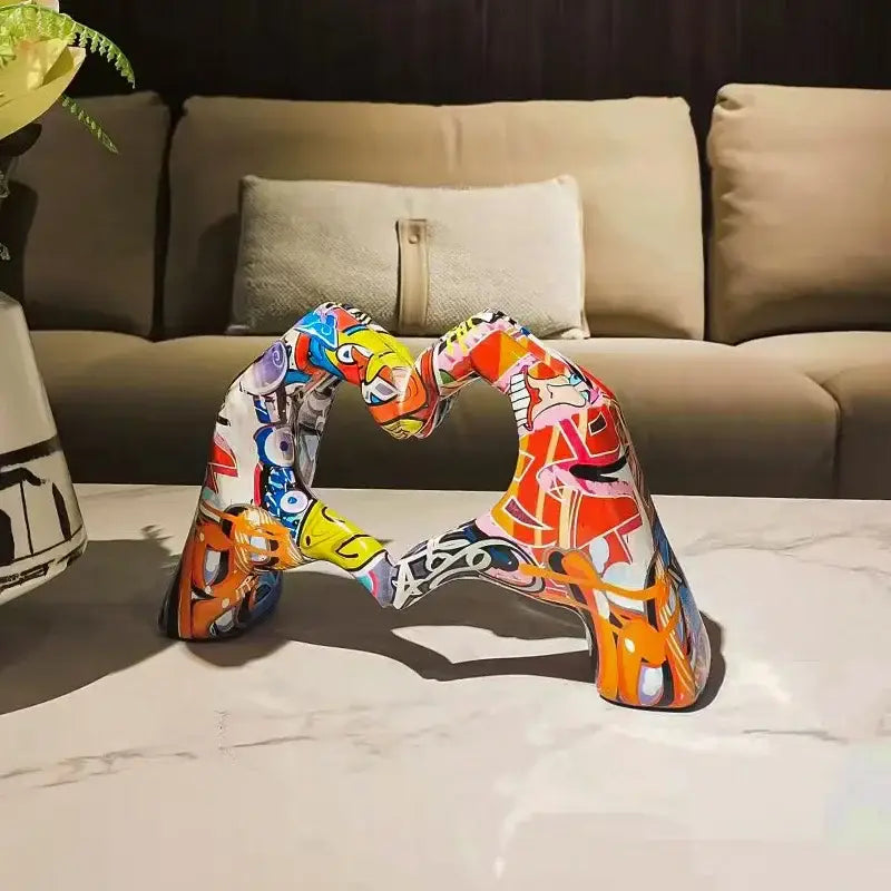 Vibrant resin ornaments featuring a colorful love heart sculpture with bold orange yellow and blue patterns for desktop decor