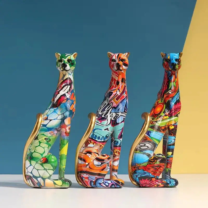 Three vibrant graffiti-style leopard resin sculpture cat figurines with gold-trimmed tails for colorful decorbites decor