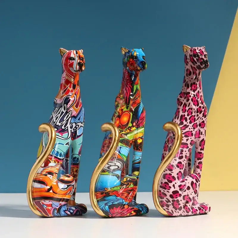 Three vibrant graffiti-style leopard resin sculptures with gold-tipped tails for colorful living room decorbites leopard decor