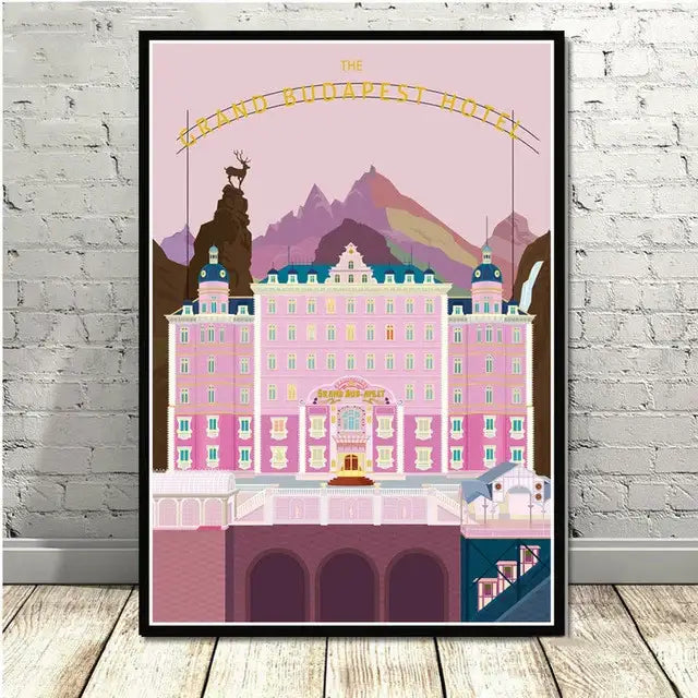 A framed decorbites grand budapest minimalist wall art set featuring a pink and teal stylized illustration with gold lettering