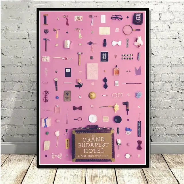 Pink framed poster with miniature movie objects on vibrant pink background featuring the grand budapest hotel decorbites grand budapest wall art