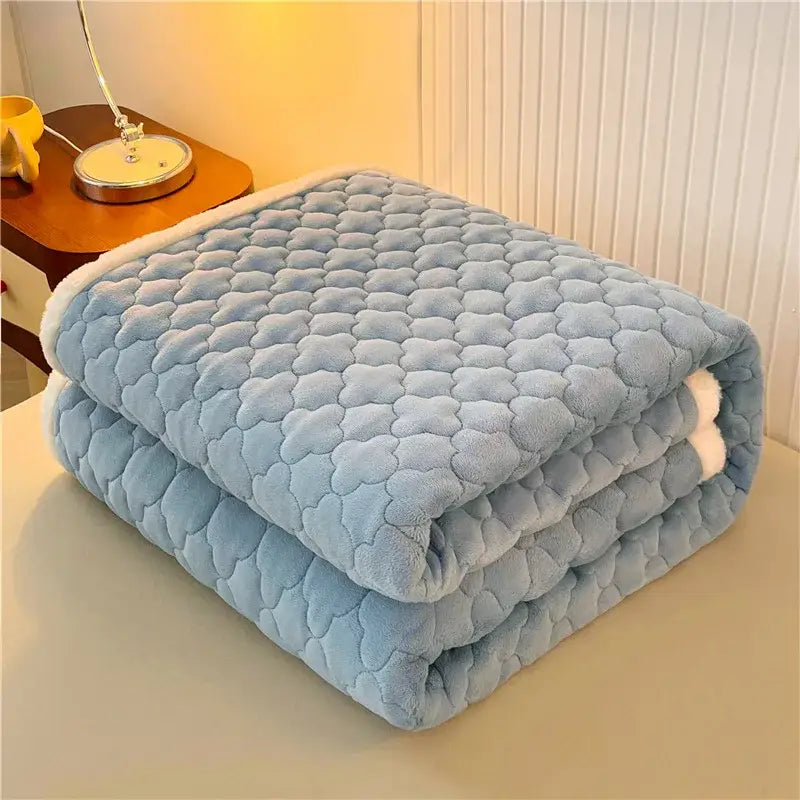 A soft light blue quilted blanket with plush texture and white fleece lining for decorbites antibacterial milk velvet mattress