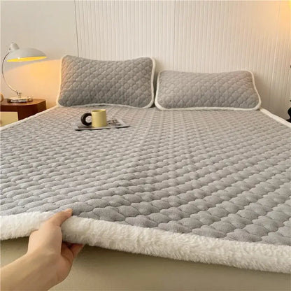 Gray quilted antibacterial milk velvet mattress pad with plush white fleece border ideal for bedroom use