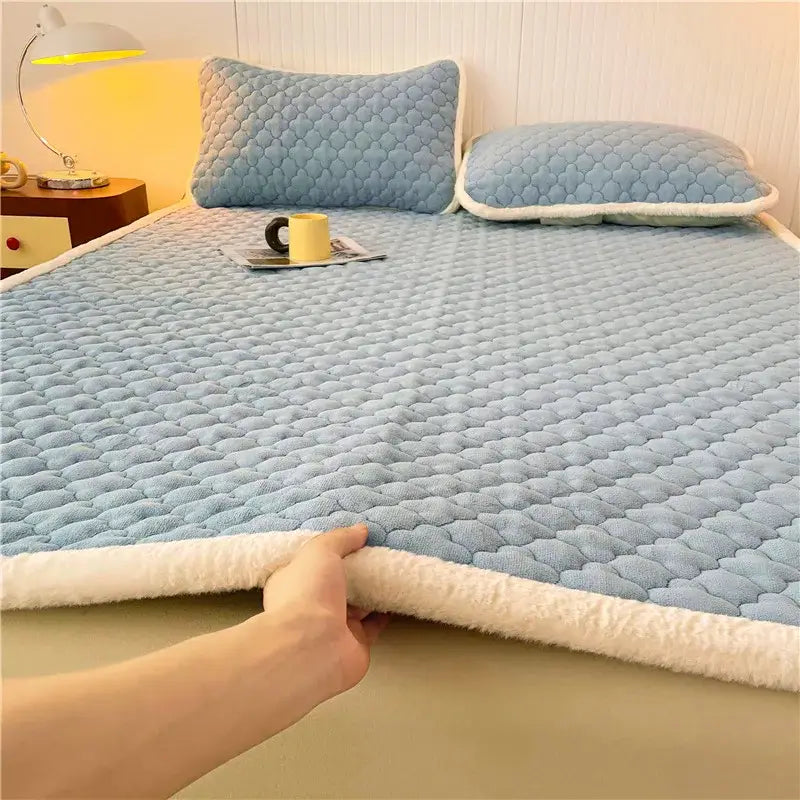 Light blue quilted bed pad with plush white fleece border on gray and white antibacterial milk velvet mattress decorbites antibacterial milk