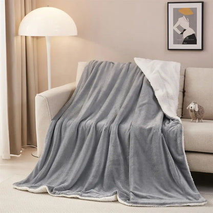 Gray and white reversible sherpa twin blanket with soft white sherpa lining and plush gray throw surface