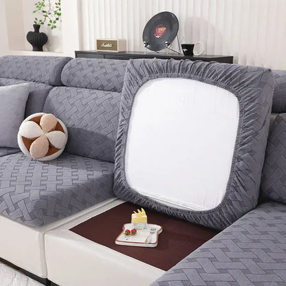 Gray and white woven elastic sofa slipcover showing gray quilted cushion cover with white central panel and elastic edges