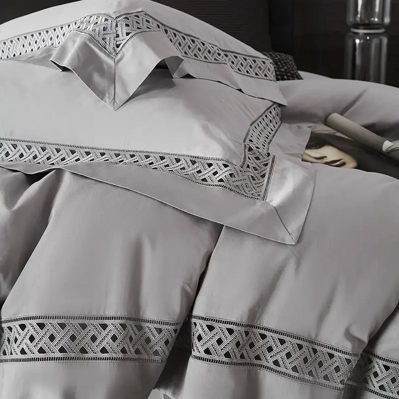 Gray and black egyptian cotton hotel bedding set with satin texture and intricate geometric embroidery along edges