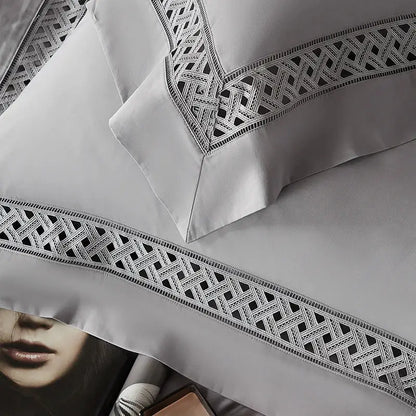 Gray satin pillowcases with intricate black geometric embroidery on edges in egyptian cotton hotel bedding set