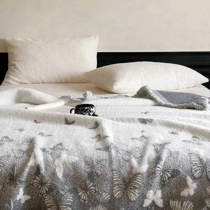 White throw blanket with soft textured surface and gray and white decorbites butterfly jacquard imitation mink fur design