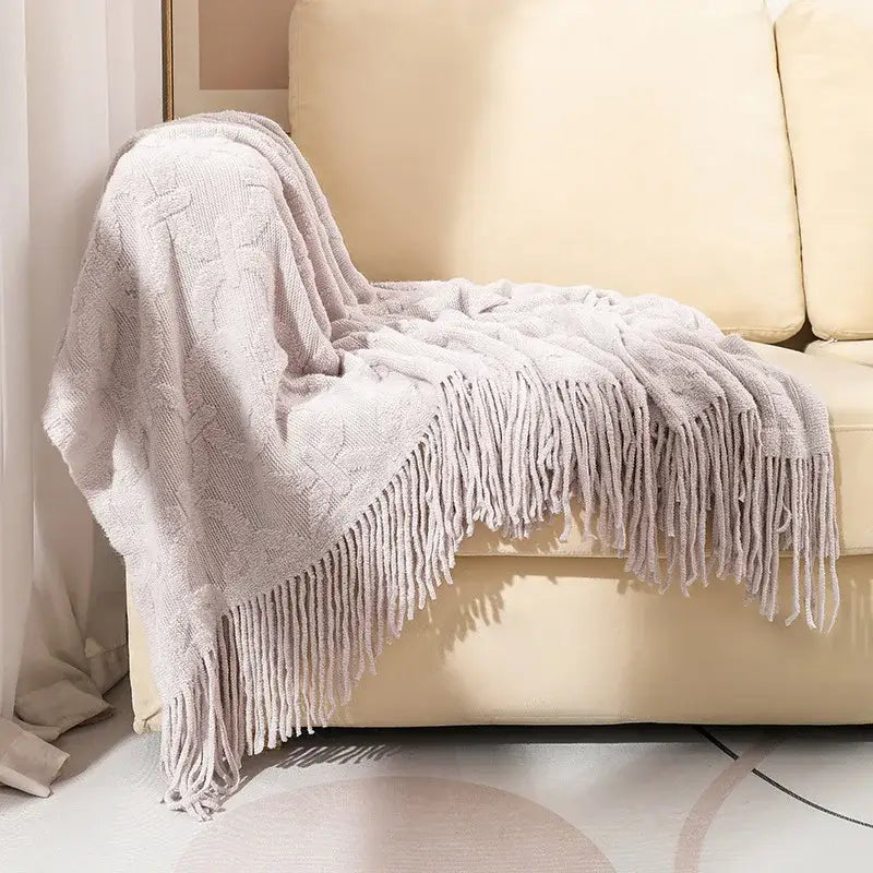 A soft light gray decorbites knit blanket with cable pattern and fringe for knit blanket sofa living room decor