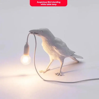 Gray ceramic lively bird resin table lamp with a white ceramic bird holding a glowing bulb in its beak for bedroom decorbites lively bird