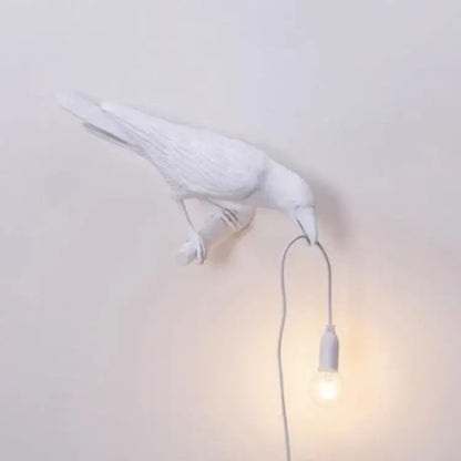 White ceramic bird wall lamp with dangling bulb complementing decorbites lively bird resin table lamp for bedroom