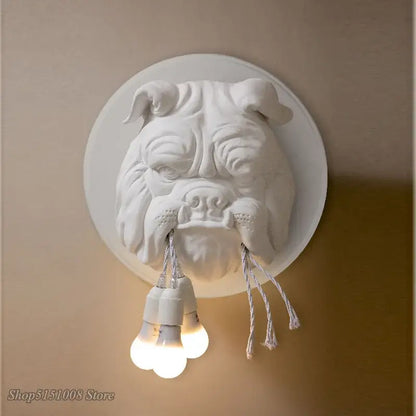 White sculpted decorbites bulldog resin wall lamp with three exposed bulbs hanging from its mouth for bedroom use