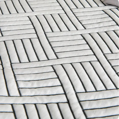White quilted mattress topper with black geometric stitching on gray cooling ice bean mesh quilted bed mat by decorbites