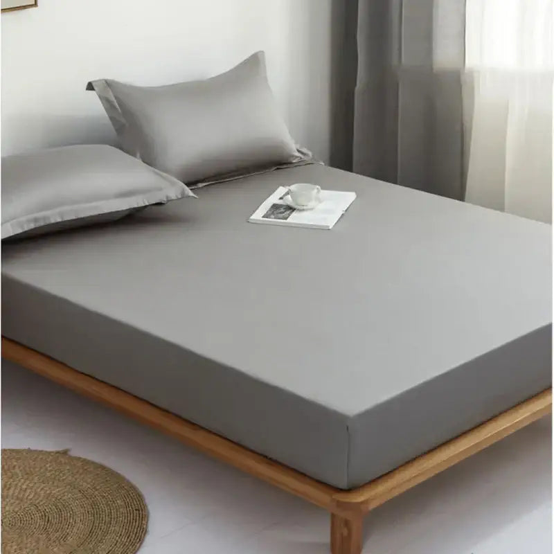 Gray decorbites cotton fitted sheet set with gray satin fitted sheet and matching pillows on wooden bed frame