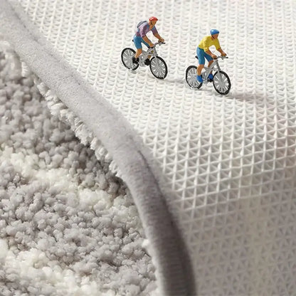 Gray geometric flocked plush bath mat showing white mesh backing featuring decorbites geometric flocked design