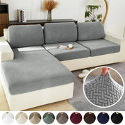 Gray herringbone-patterned stretch sofa cover protecting living room furniture with elastic fabric for a snug fit