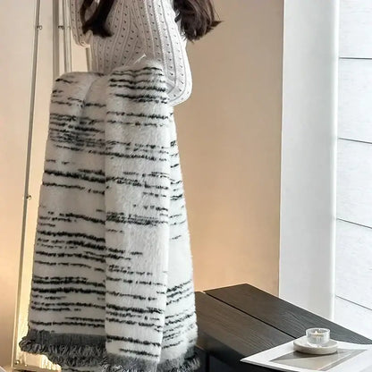 A cozy long white and black striped knit skirt with frayed hem paired with a gray leopard print luxury mink fur blanket decorbites leopard print