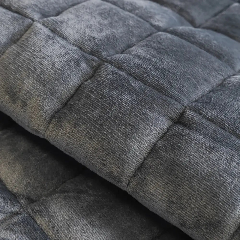 Dark gray quilted sofa towel with plush textured surface and square stitching for living room cushion pad