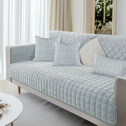 Light blue quilted sofa cover with soft textured fabric and diamond stitching for living room furniture protection