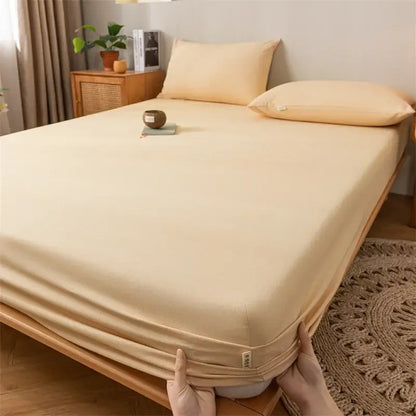 Beige stretchy fitted sheet with elasticized edges and smooth textured surface in a gray red black plaid cotton sheet set by decorbites coarse cloth