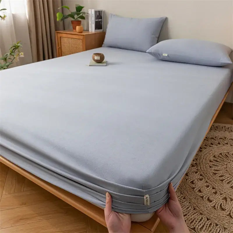 Light blue fitted sheet with elasticized edges and fabric tag in gray red and black plaid cotton sheet set by decorbites coarse cloth
