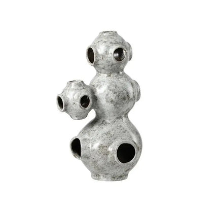 Gray speckled ceramic ornament with three interconnected bulbous sections and circular openings for abstract planet decorbites abstract planet