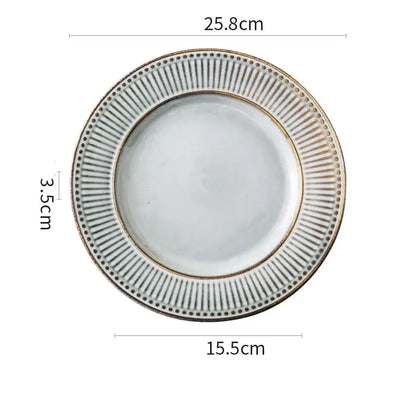 White ceramic plate with ribbed rim and gold accents from gray and white striped decorbites ceramic wedding tableware set