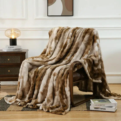A mottled brown and cream fuzzy faux fur blanket draped over an armchair perfect for decorbites fuzzy faux decor